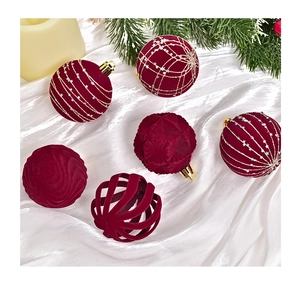 Detail of red velvet Christmas ornaments with gold patterns on white silk fabric
