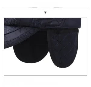 Close-up of quilted pattern and thick ear protection on men's winter baseball cap