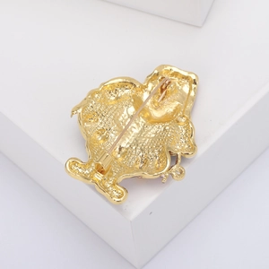 Detailed back view of gold alloy Santa brooch showing textured finish and pin fastener