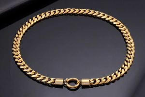 Macro detail of 18K gold plated Cuban link chain with sparkling pavé diamond settings