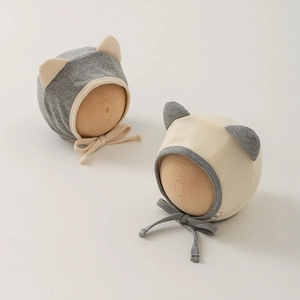 Newborn knitted baby hats with cat ears and chin straps in grey and beige color mix