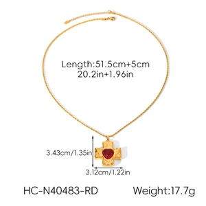 Detailed view of golden cross pendant with a red heart gemstone and size specifications
