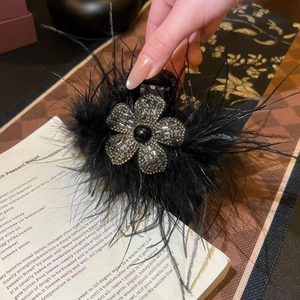Elegant black acrylic feather hair claw clip with rhinestones and flower design