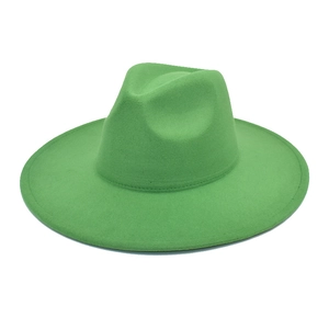 Detailed flat lay of a bright green wide brim wool felt fedora with heart-shaped crown