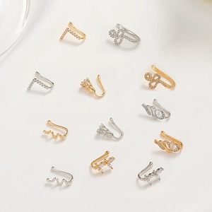 Detailed view of 12 gold and silver non-piercing copper nose clips with zircon inlays