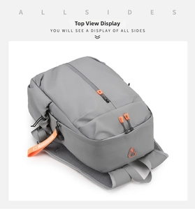 Detail view of water-resistant gray backpack with orange zippers and breathable mesh back