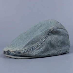 Detail shot of vintage washed denim flat cap showing soft brim and twill texture