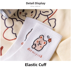 Detail shot of white cotton mid-calf socks with cute cartoon bear and Get very rich text