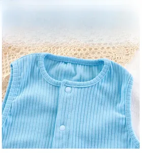 Detailed macro view of the baby bodysuit's blue ribbed cotton fabric and snap button neckline