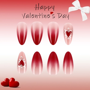 Detail of red ombre almond press-on nails with 3D hearts and pearls for Valentine's Day