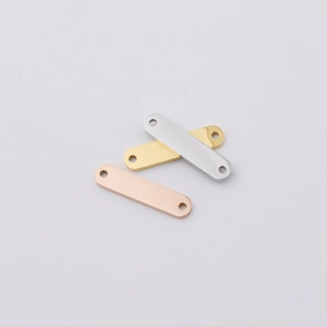 Macro view of rectangular stainless steel tags in silver, gold, and rose gold finishes