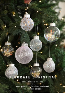 Close-up of glittery Christmas tree ornaments with warm string lights and festive glow