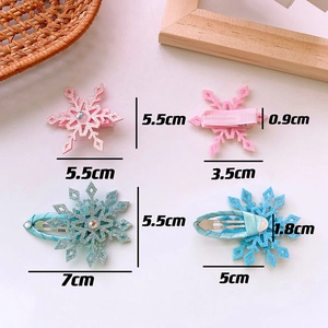 Detail showing pink and blue glitter snowflake hair clips with dimensions and fabric backing