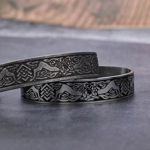 Vintage stainless steel open bangles with Celtic wolf head patterns on stone surface