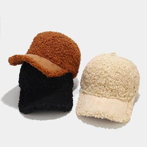 Detailed texture of lamb wool baseball caps in brown, black and beige colors