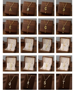 Detailed grid view of individual gold titanium steel capital letter pendants A to T