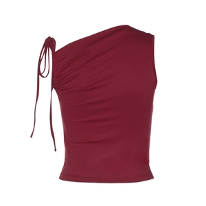 Detail of red one-shoulder sleeveless top featuring side drawstring ruched texture