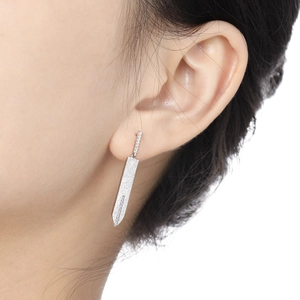 S925 sterling silver sword earrings with zircon inlays on model ear side view