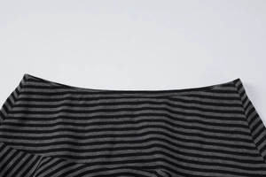 Detail view of the wide neckline on this black and gray striped knit top for women