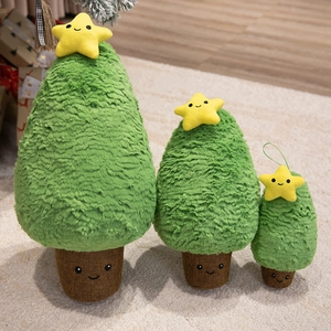 Three plush Christmas tree stuffed toys in small, medium, and large sizes on a rug