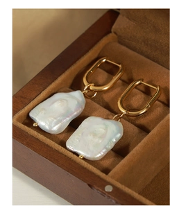 Detailed view of baroque freshwater pearl earrings with gold-plated rectangular hoops