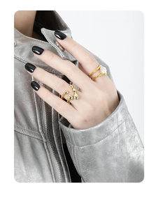 Detail of minimalist gold irregular hollow ring and pearl ring on model finger