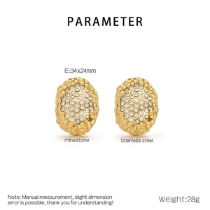 Macro view of gold stainless steel oval earrings with honeycomb texture and rhinestones