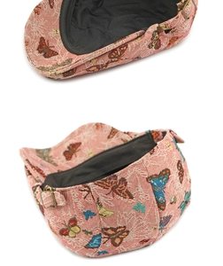 Close-up of pink jacquard newsboy cap with butterfly patterns and metal buckle