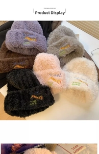 Detail view of plush fuzzy knit beanies in multiple colors with embroidered lettering