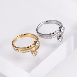 Detail view of gold and silver spiral rings with large zircon on white steps