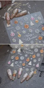 Close-up of 3D embossed Christmas nail stickers featuring snowflakes and golden trees