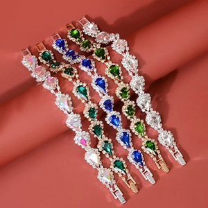 Detail view of crystal teardrop bracelets in assorted silver and gold metal finishes