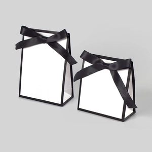 Minimalist black and white gift bags with satin bow ribbon detail in two different sizes