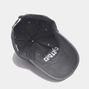 Detail view of washed dark grey cotton baseball cap interior with adjustable metal buckle