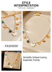 Detail of pearl necklace with gold insect pendants and colorful cherry charms