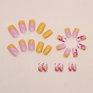 Floral press-on nail kit featuring sweet pink and yellow French tips with resin finish