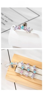 Detailed macro view of curved zircon stud earring featuring multi-color gemstone inlay