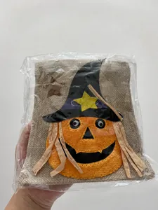 Detail showing a Halloween drawstring gift bag featuring a pumpkin and wizard hat design