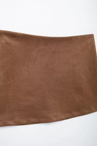 Macro detail of the caramel brown suede fabric texture and stitching on the women blazer
