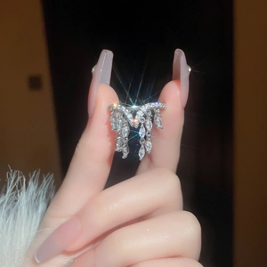 Close-up of silver tassel ring with marquise-cut gems and pavé zircon detailing