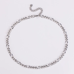 Macro detail of silver 5.5mm Figaro chain links with lobster clasp and extender