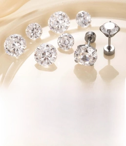 Macro detail of silver titanium steel earrings with 6mm and 8mm round brilliant zircon