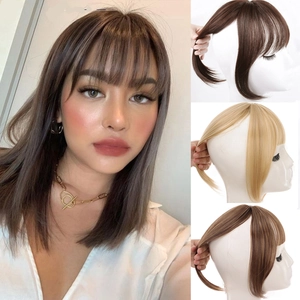 Detail view of 3D French bangs hairpieces in dark brown and blonde synthetic hair