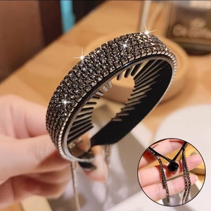 Detailed view of black rhinestone hair claw clip with shimmering tassel chain fringes