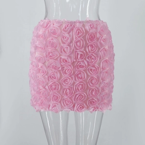 Close-up of pink mini skirt featuring textured 3D rose floral appliques on fabric