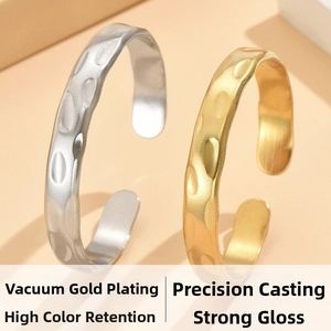 Detail of gold and silver hammered open bangles with high luster vacuum plating