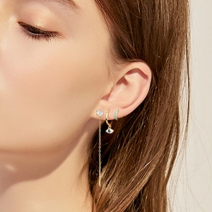 Detailed view of S925 silver six-prong diamond stud and evil eye dangle earring set