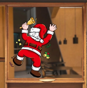 Detail of Santa Claus window sticker with golden bells and stars on a glass window