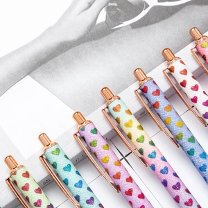 Glitter retractable ballpoint pens with heart patterns and rose gold metal accents