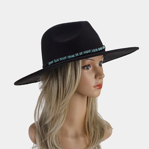 Detail of black wide brim wool fedora hat featuring turquoise beaded ethnic band